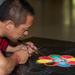 One of the monks works on the Sand Mandala