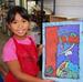 A happy camper shows off her painting.