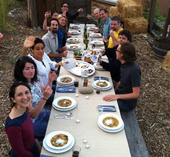 The artists in residence eat together at a communal table.
