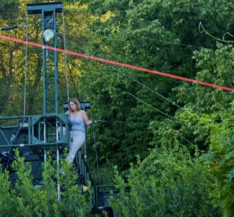 Nancy Popp on the scaffolding of the Garden Theatre, with her orange mason line in the foreground.